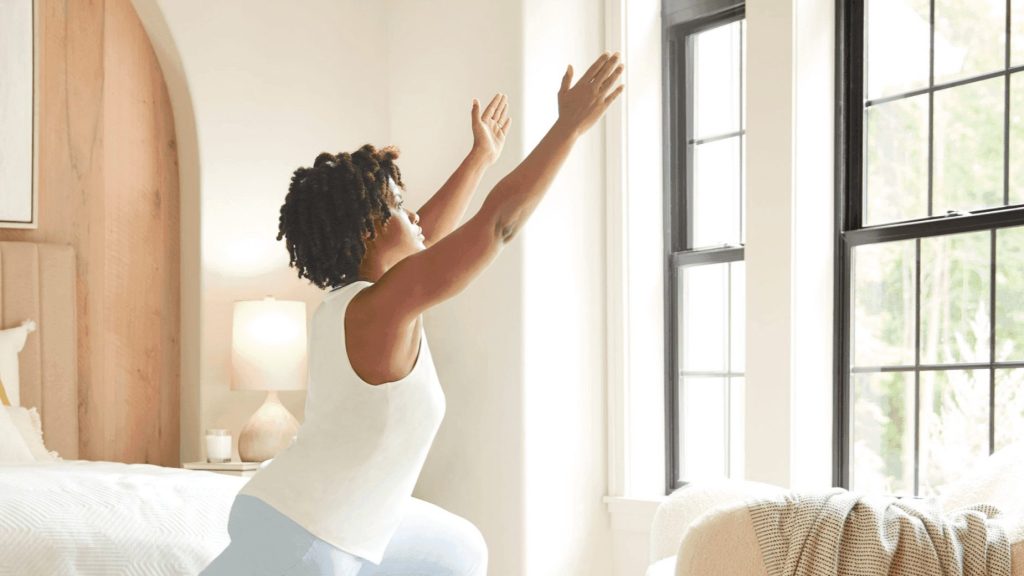 Savant Interfaces: #1 Intelligent Design 5 a woman stretching her arms with knowing she can control her Savant system with her voice